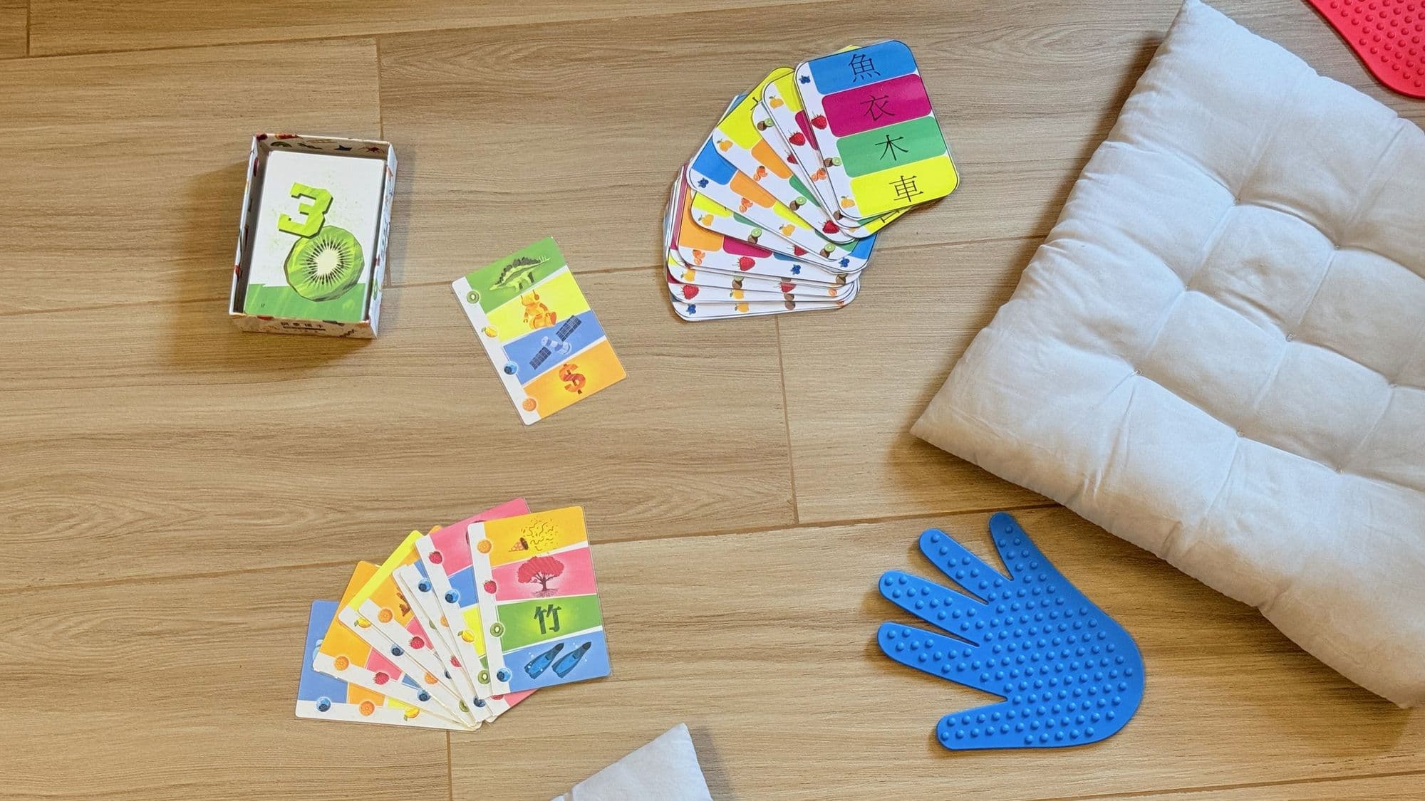 Chinese literacy and sensory integration training — flashcards and sensory hand-and-foot pads on the floor