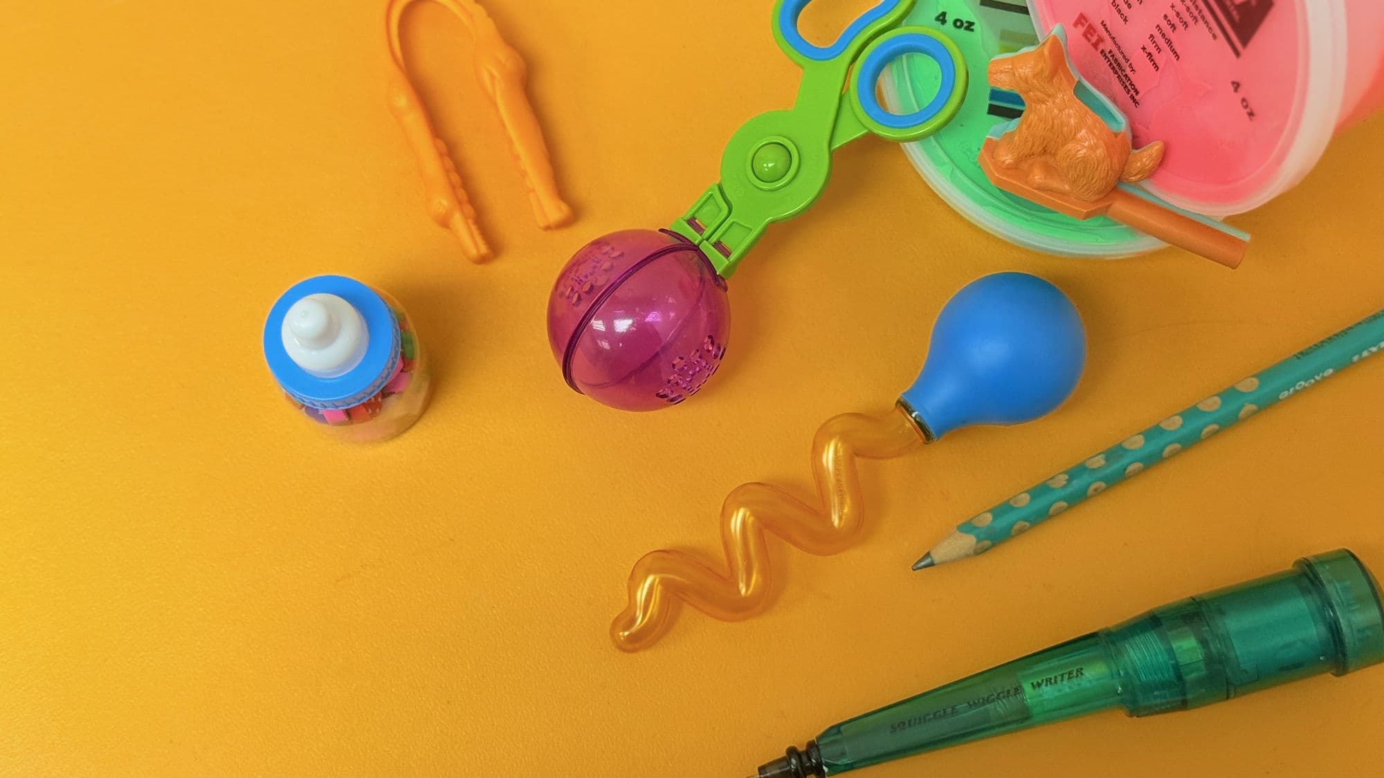 Paediatric fine motor training tools — TheraPutty, training tweezers, Squiggle Pen, and writing pencils